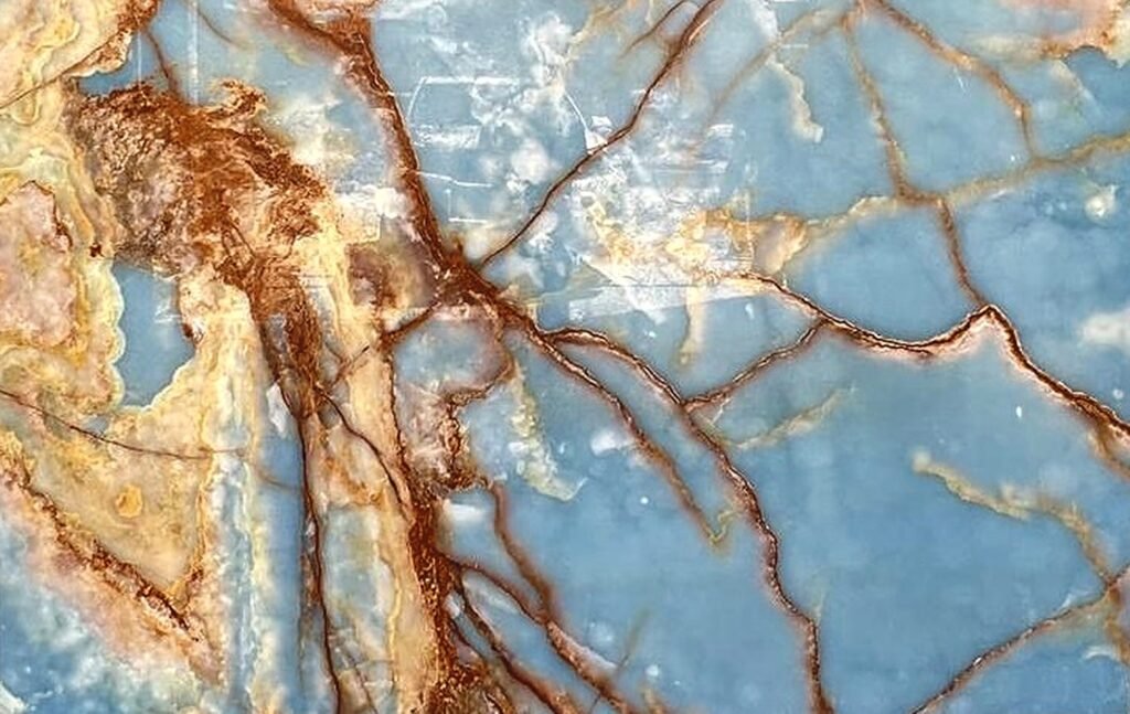 Blue Onyx slab with translucent sky-blue fields and rust and copper veining