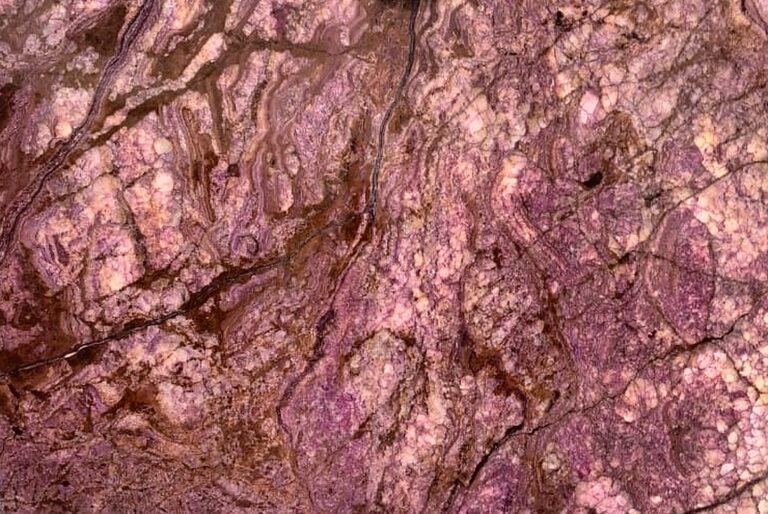 Exotic Pink Onyx slab with pink, mauve and violet crystal bound by rust and gold veins