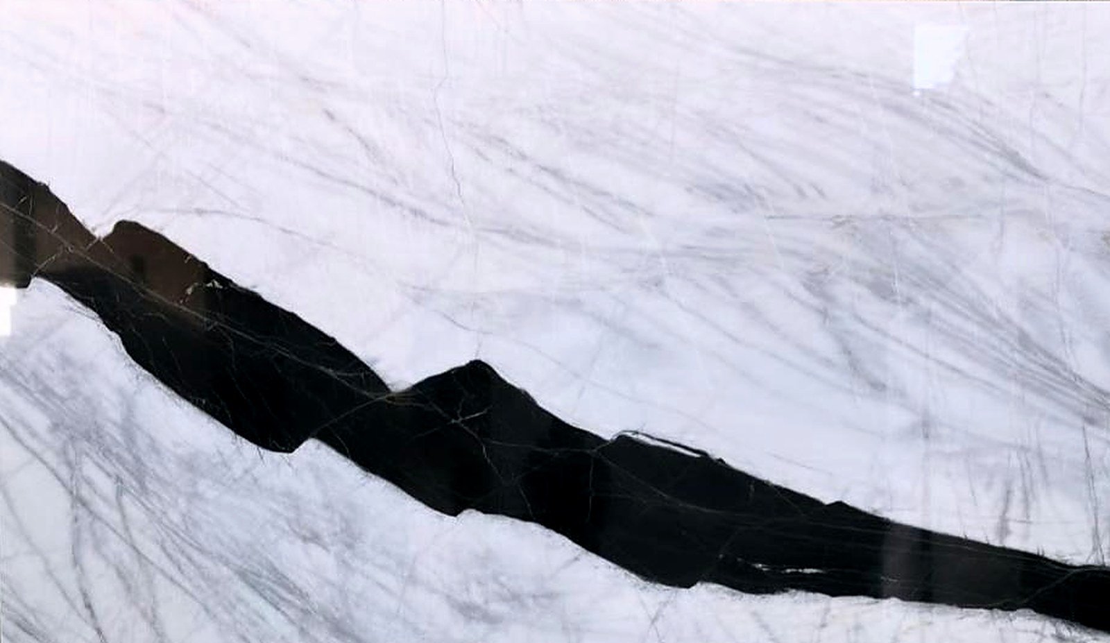 Persian Panda White Marble slab with a sweeping diagonal belt of deep black veining