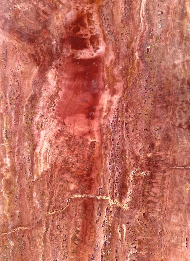 Persian Red Travertine vein-cut slab in deep terracotta, crimson and burnt orange with ribbons of gold